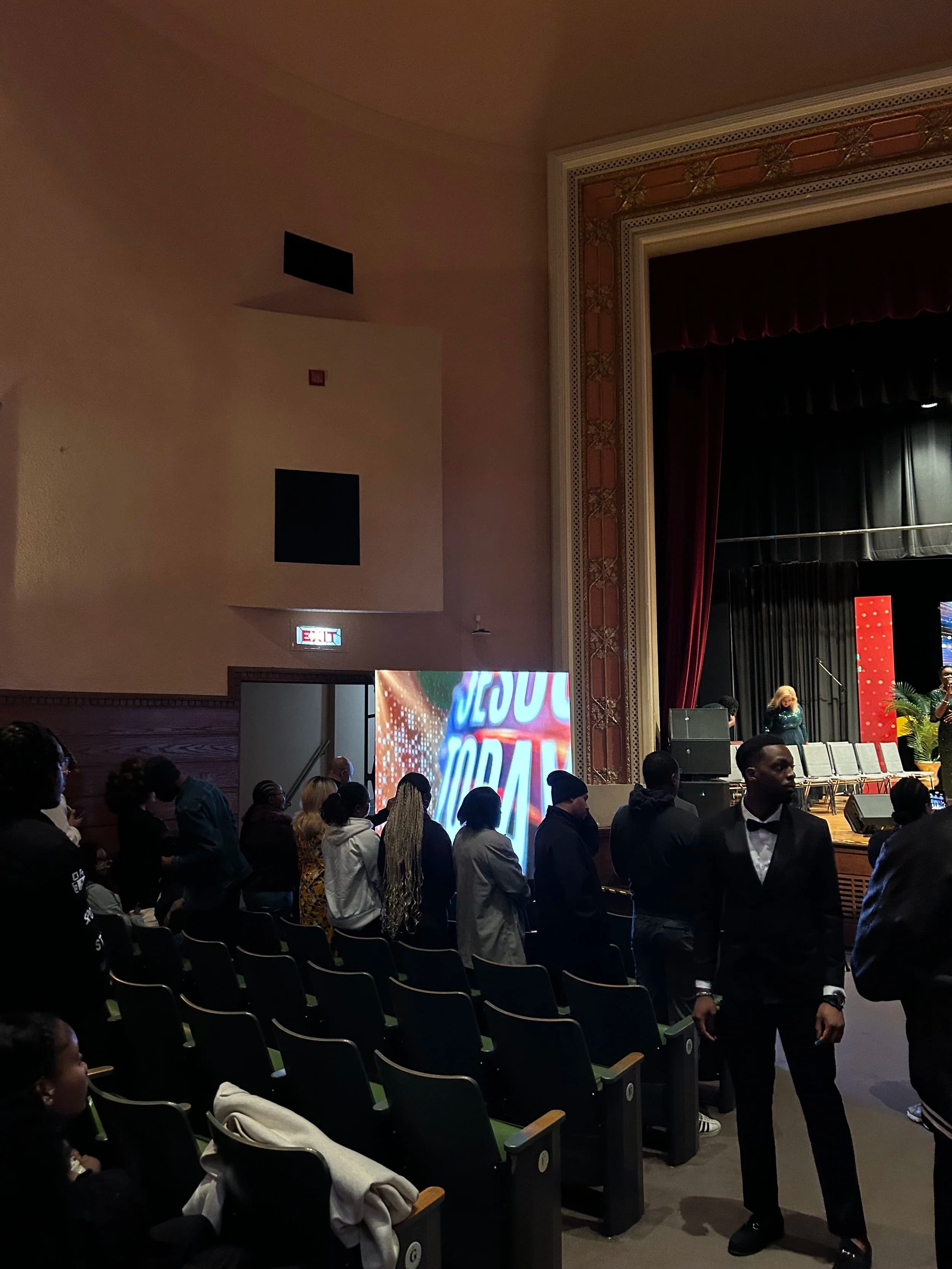 Side view of an Ottawa theatre full of attendees with our LED wall lit on stage