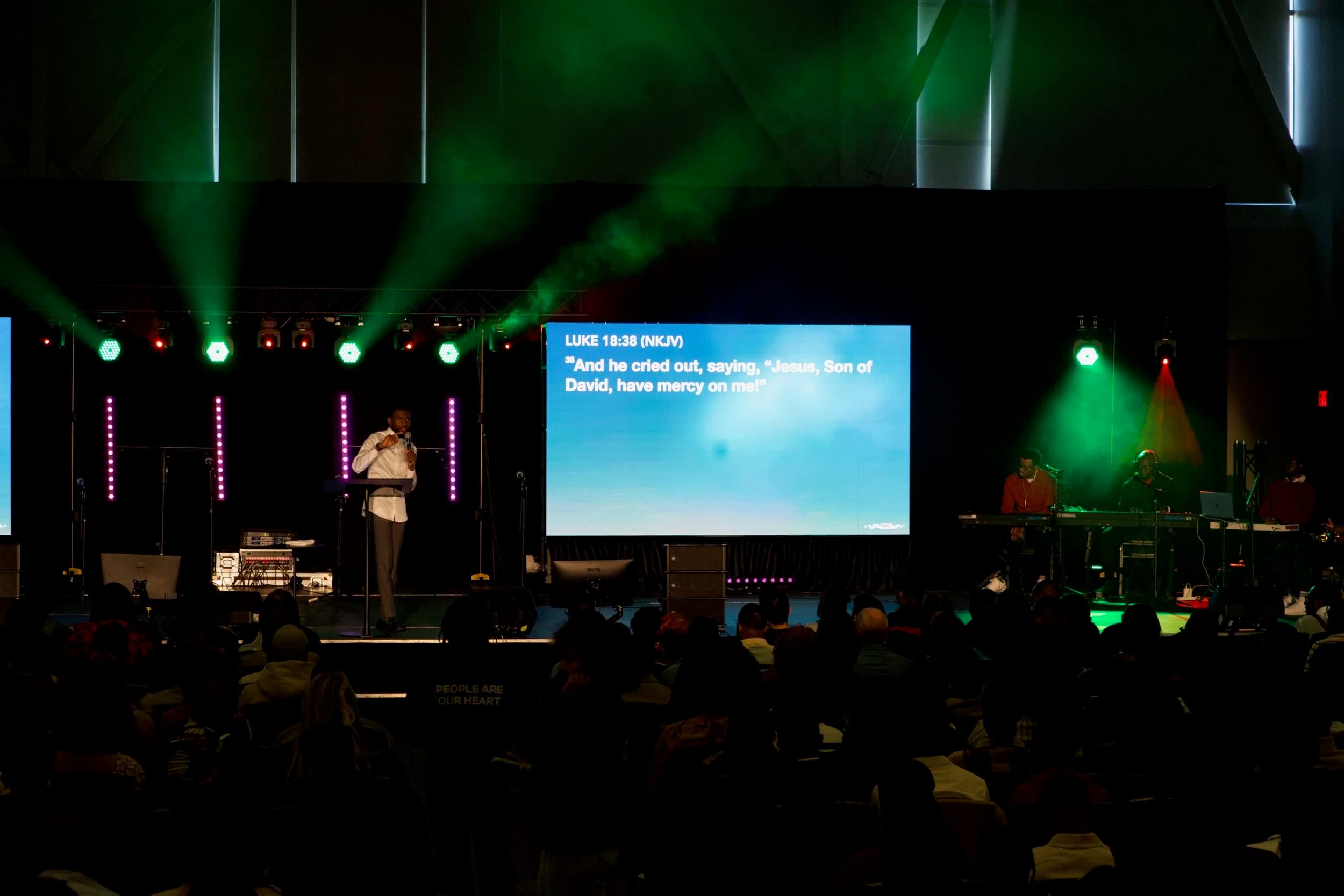 Full production LED wall with green and magenta stage lighting at an Ottawa worship night
