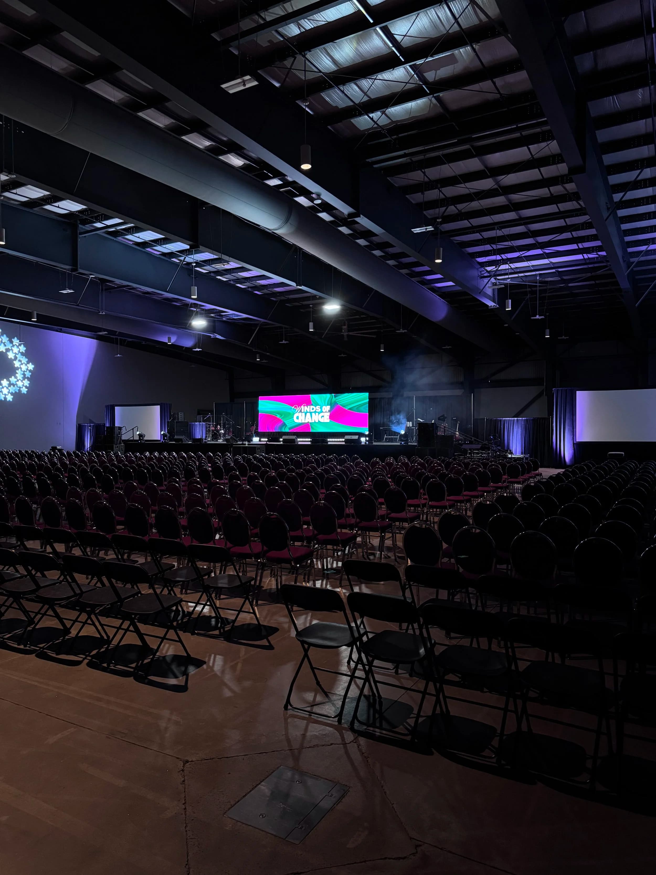 Large LED wall at an Ottawa government conference with rows of delegates and a podium on stage