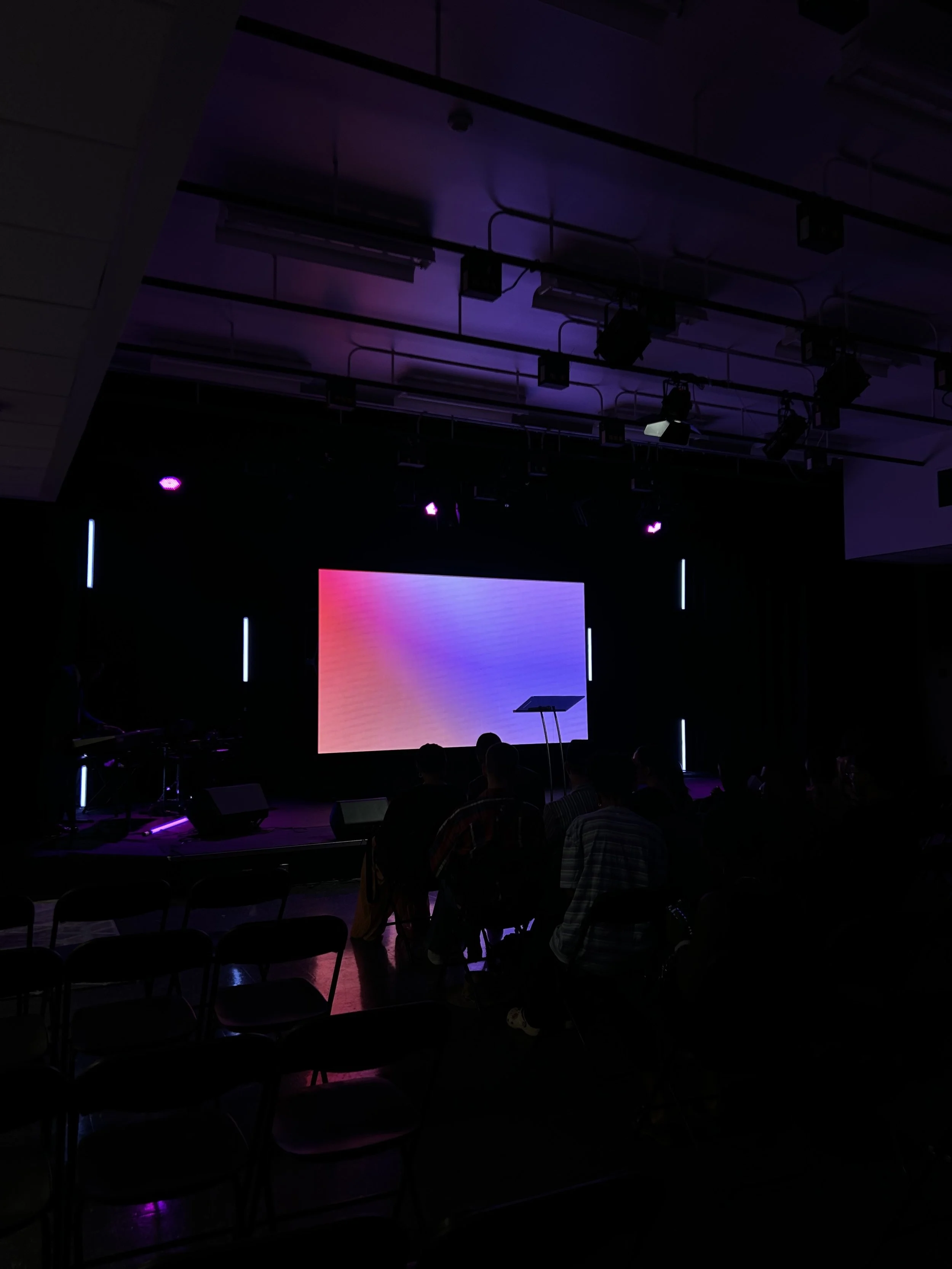 Bright LED wall lit in purple and pink — readable across the room even at low ambient light