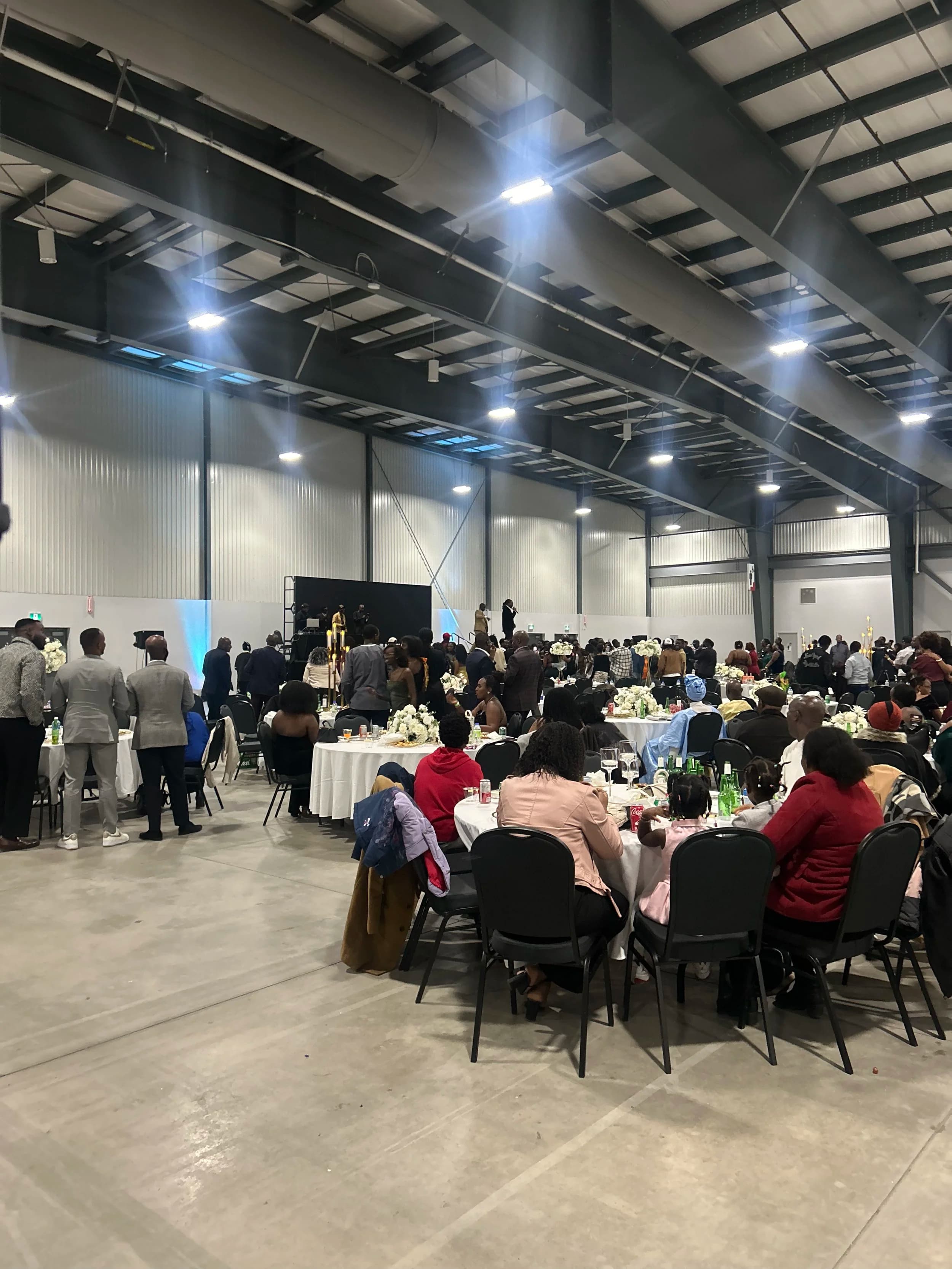 Brand activation in an Ottawa hall with our LED wall behind the stage and audience seated at rounds
