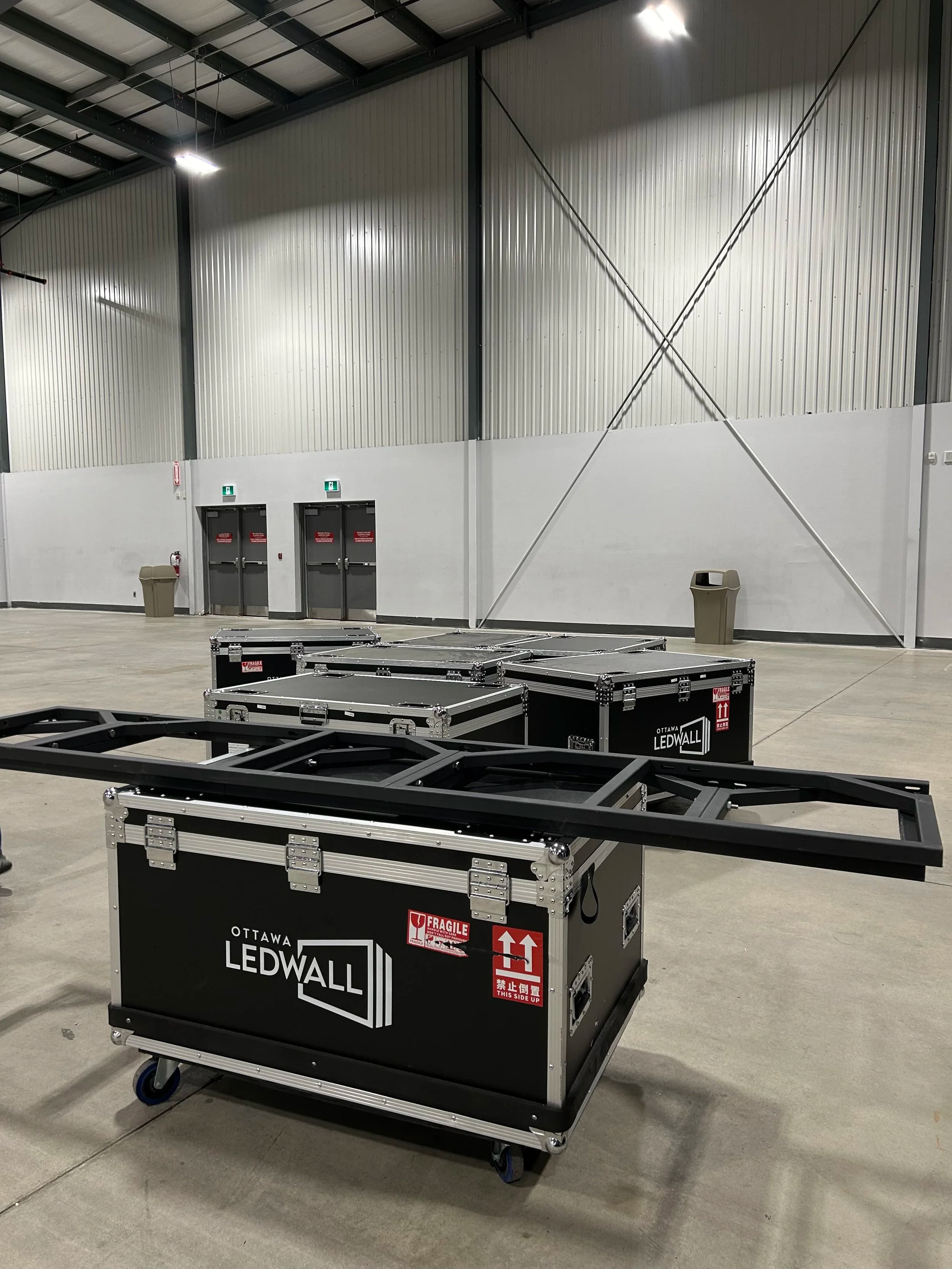 Ottawa LEDWALL branded flight cases staged in a venue ahead of load-in