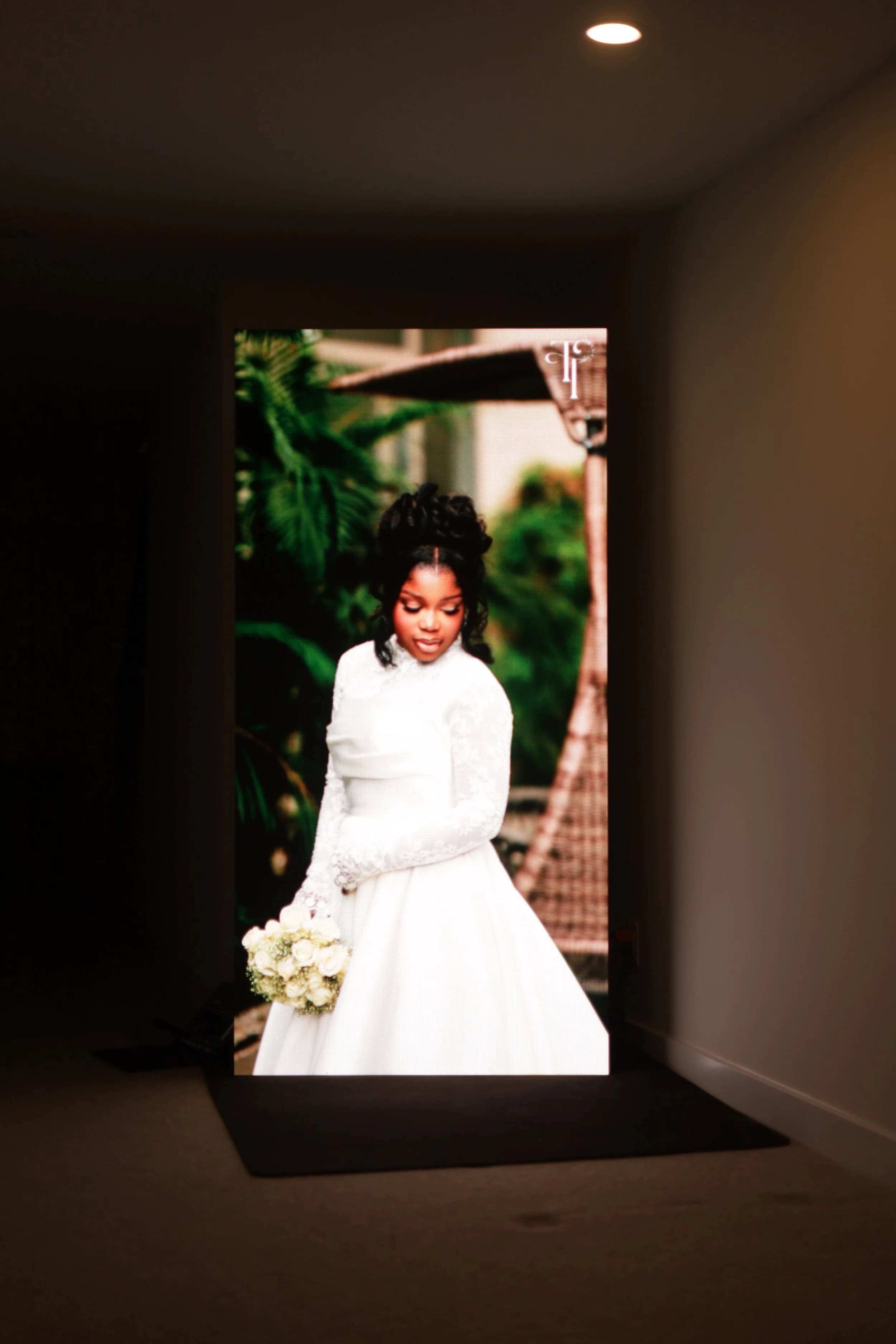 Intimate Ottawa wedding portrait of the bride glowing on our LED wall in a softly lit lobby